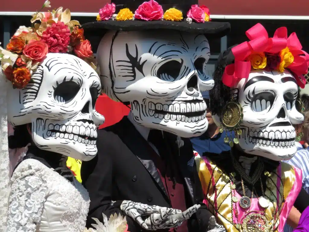 people wearing skeleton masks for Dia de los muertos festival