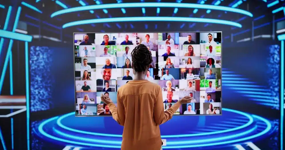 A woman looking at a giant digital display wall at a technology experience event.