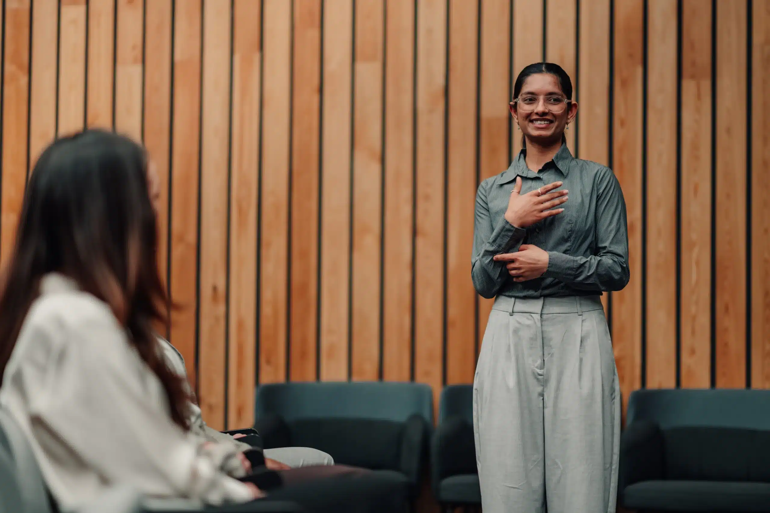 Young businesswoman speaking confidently at a corporate conference